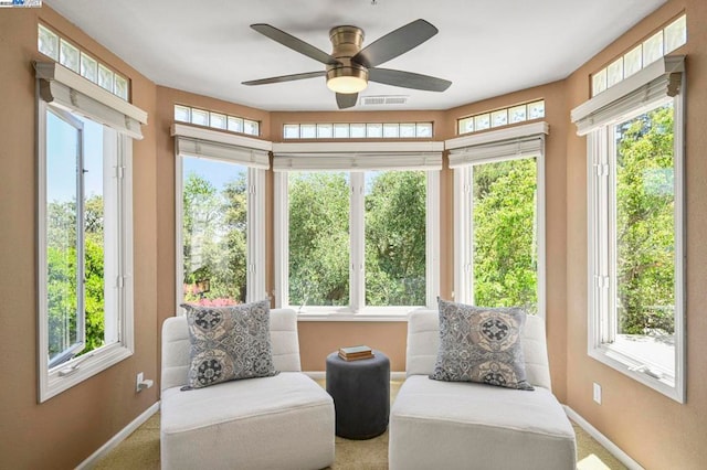 sunroom / solarium featuring ceiling fan