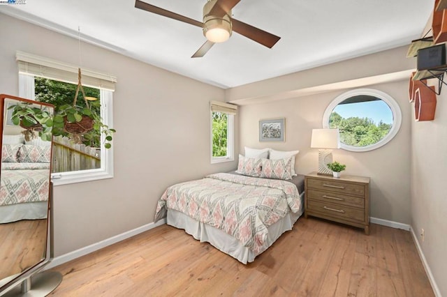 bedroom with ceiling fan and light wood-type flooring