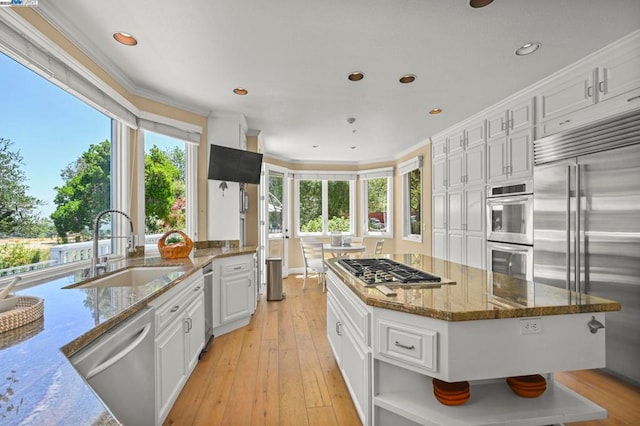 kitchen featuring sink, crown molding, stone counters, stainless steel appliances, and white cabinets