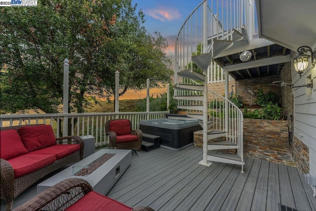 deck at dusk featuring an outdoor living space with a fire pit