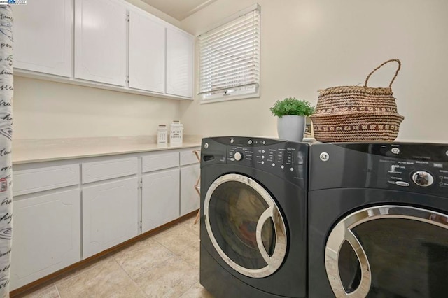 laundry room featuring cabinets, washer and dryer, and light tile patterned floors