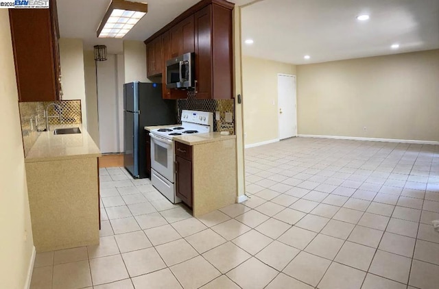 kitchen with light tile patterned flooring, backsplash, sink, and white range with electric stovetop