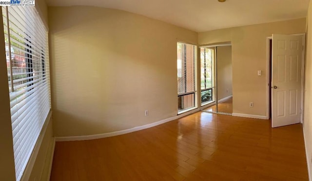 spare room with hardwood / wood-style flooring