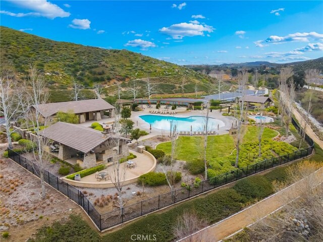 exterior space with a patio area, a fenced backyard, and a mountain view