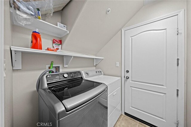 laundry room featuring laundry area, light tile patterned flooring, and washer and dryer