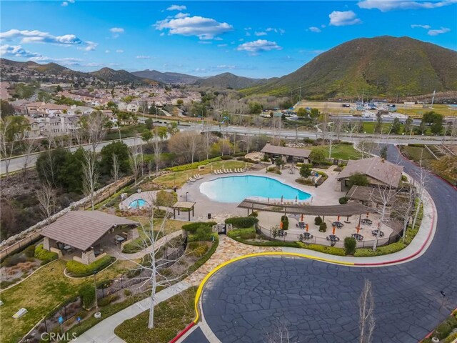 view of swimming pool with a patio area and a mountain view