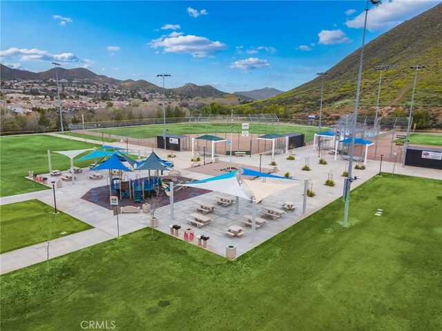 view of property's community featuring a mountain view and a lawn