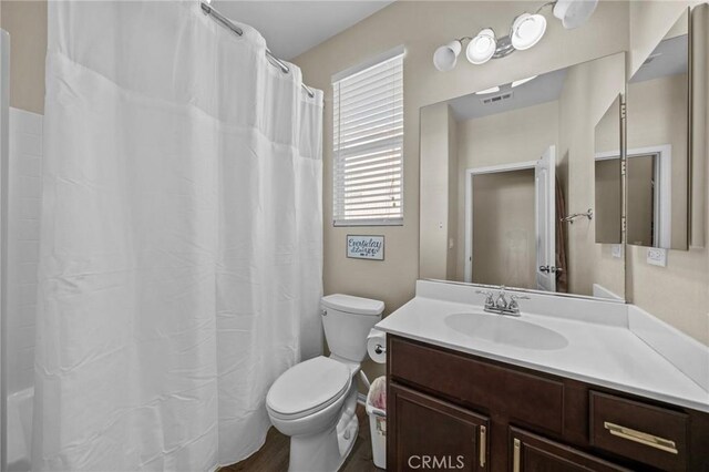 bathroom with toilet, curtained shower, visible vents, and vanity