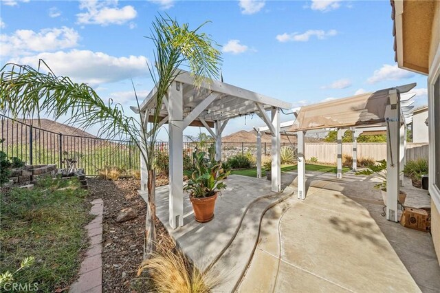 view of patio / terrace with a fenced backyard and a pergola