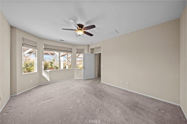 unfurnished bedroom featuring carpet floors, visible vents, baseboards, and a ceiling fan