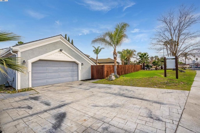 exterior space featuring a garage and a lawn