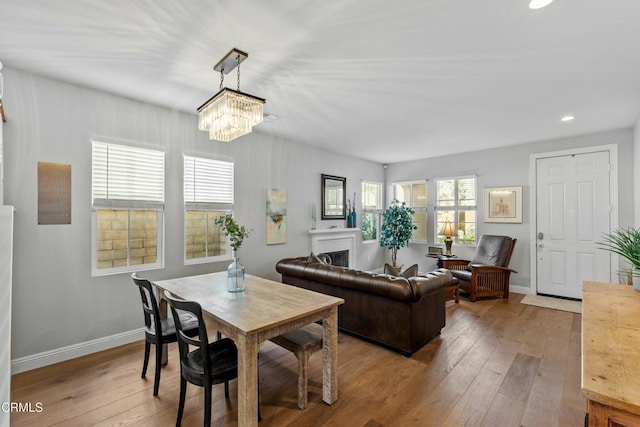 dining area featuring hardwood / wood-style flooring and a chandelier