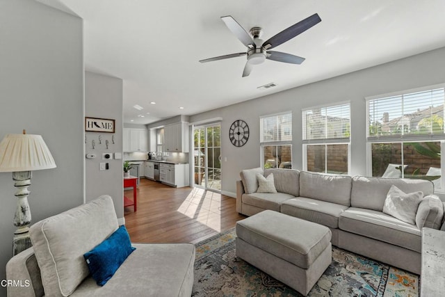 living room featuring hardwood / wood-style flooring and ceiling fan