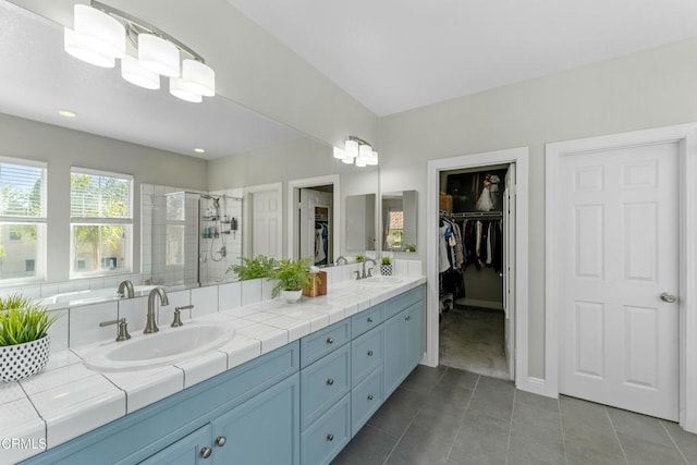 bathroom featuring vanity, tile patterned flooring, and a shower with door