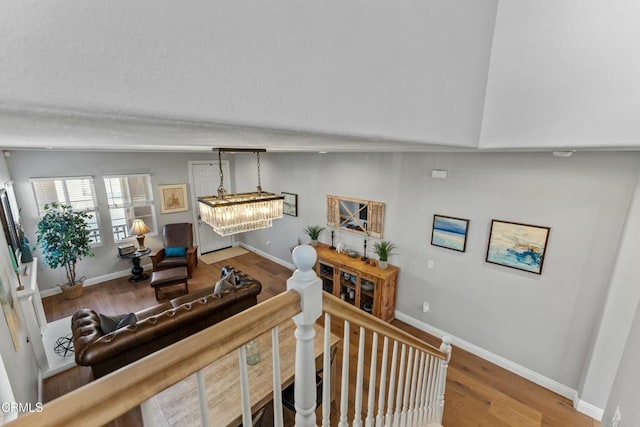 living room featuring an inviting chandelier and hardwood / wood-style floors