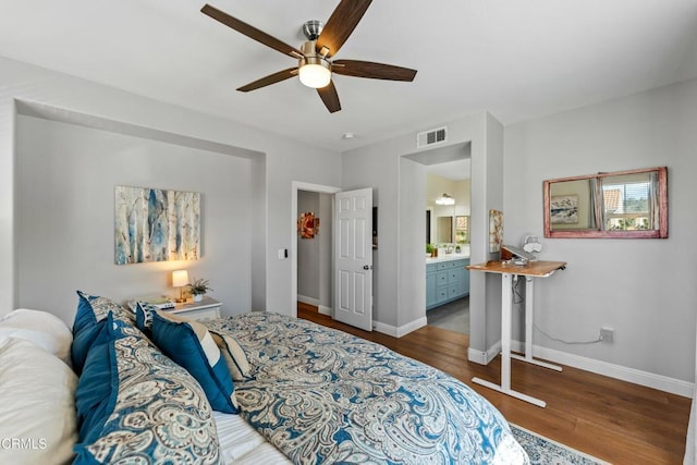 bedroom featuring ceiling fan, dark hardwood / wood-style floors, and ensuite bath