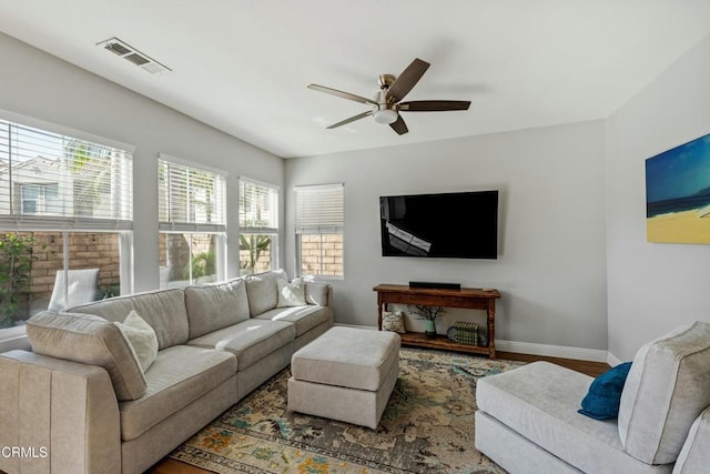 living room featuring hardwood / wood-style floors and ceiling fan