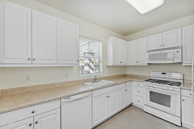 kitchen featuring white cabinetry, sink, and white appliances