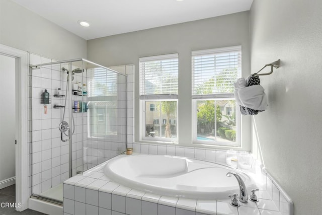 bathroom featuring shower with separate bathtub