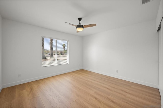 empty room with ceiling fan and light hardwood / wood-style floors