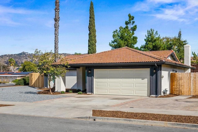 view of front of home featuring a garage and a mountain view