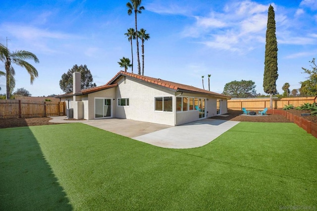 back of property featuring a patio, cooling unit, and a lawn