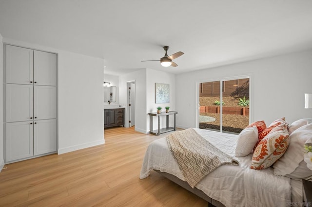 bedroom featuring ceiling fan, access to outside, ensuite bathroom, and light wood-type flooring