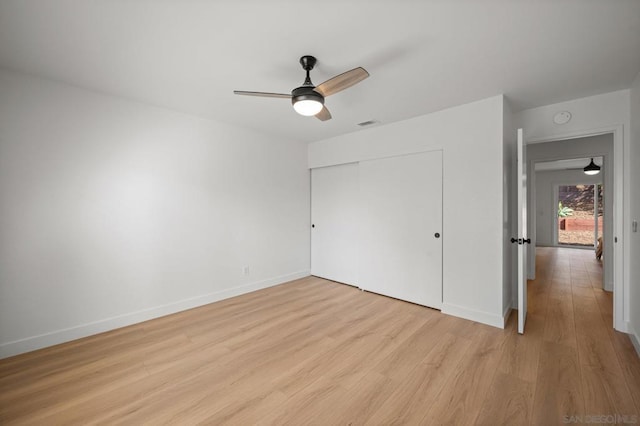 unfurnished bedroom featuring a closet, ceiling fan, and light wood-type flooring