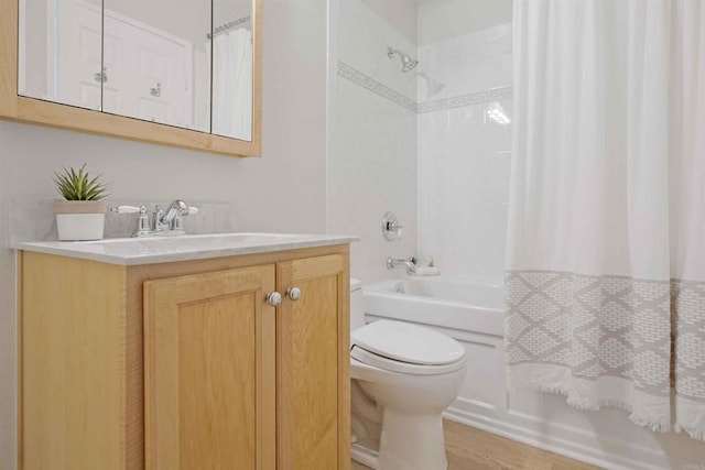 full bathroom with toilet, vanity, and shower / bath combo with shower curtain