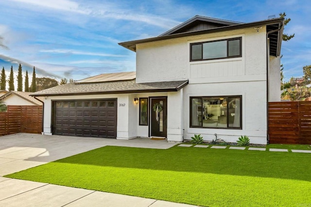 view of front of home featuring a garage and a front lawn