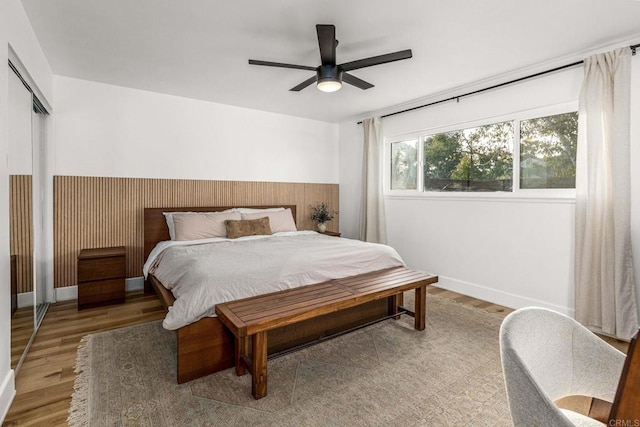 bedroom featuring wood-type flooring, a closet, and ceiling fan