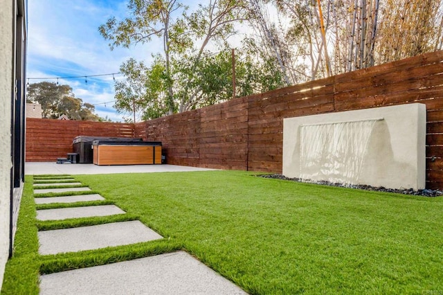 view of yard with a hot tub and a patio area