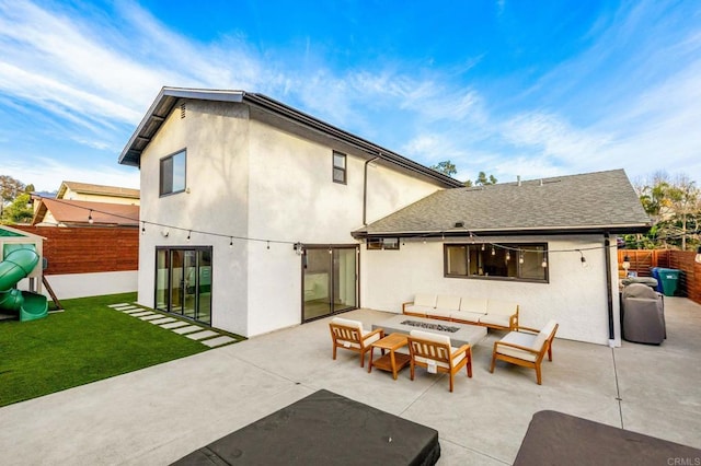 rear view of property featuring outdoor lounge area, a patio, and a playground