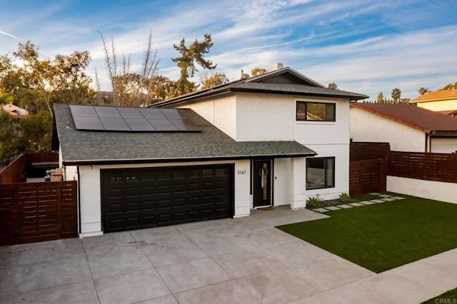 view of front of house featuring a front lawn and solar panels