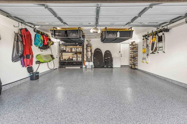 garage with a garage door opener and water heater