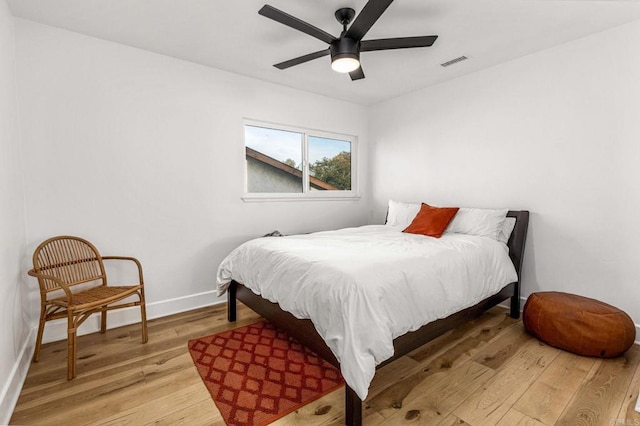 bedroom with hardwood / wood-style floors and ceiling fan