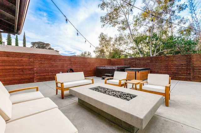 view of patio / terrace featuring an outdoor living space with a fire pit and a hot tub