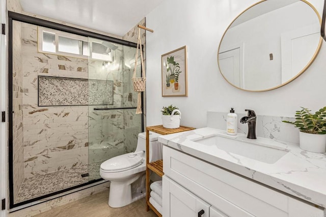 bathroom featuring hardwood / wood-style flooring, toilet, vanity, and walk in shower