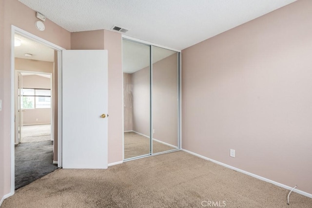 unfurnished bedroom with carpet floors and a closet