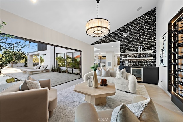 living room featuring high vaulted ceiling, beverage cooler, and bar area