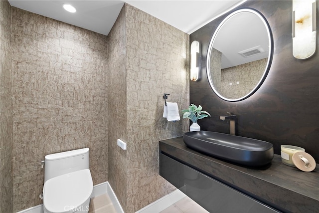 bathroom featuring vanity and toilet