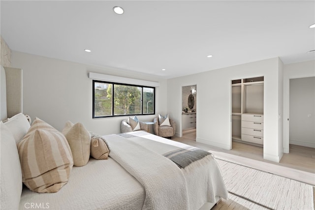 bedroom featuring light wood-type flooring and a closet