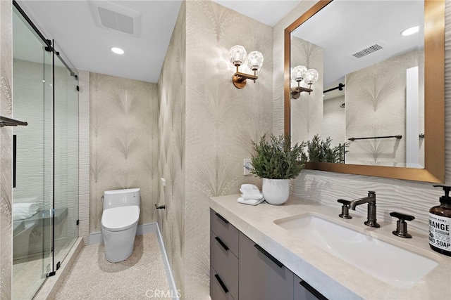 bathroom featuring toilet, an enclosed shower, and vanity