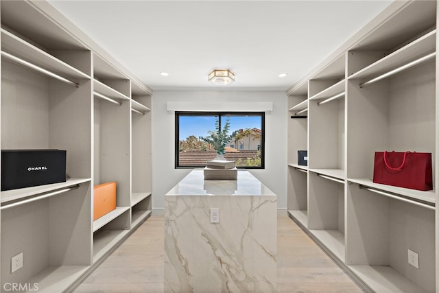 walk in closet featuring light hardwood / wood-style flooring