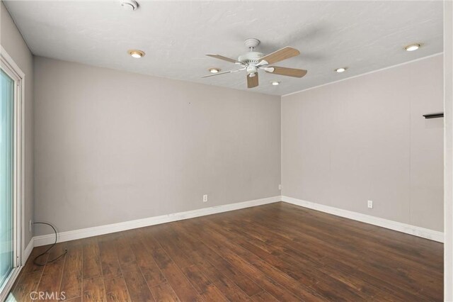 unfurnished room with dark hardwood / wood-style floors and ceiling fan