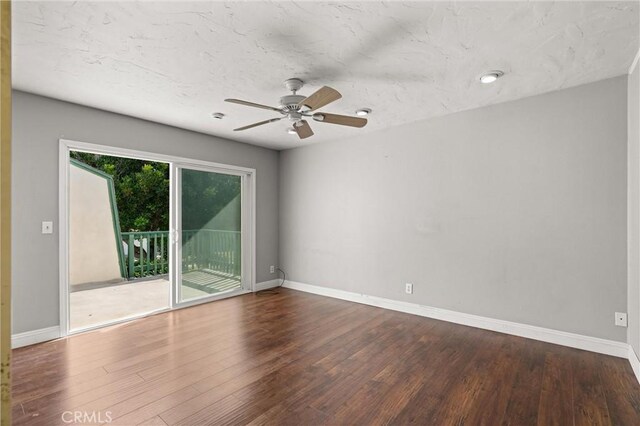 empty room featuring hardwood / wood-style flooring and ceiling fan