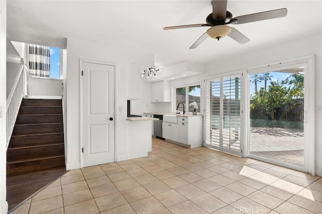 interior space featuring sink, light tile patterned floors, and ceiling fan