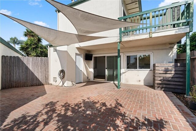 back of property with a patio and a balcony