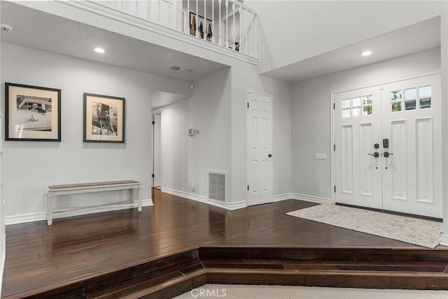 foyer with hardwood / wood-style flooring and a high ceiling