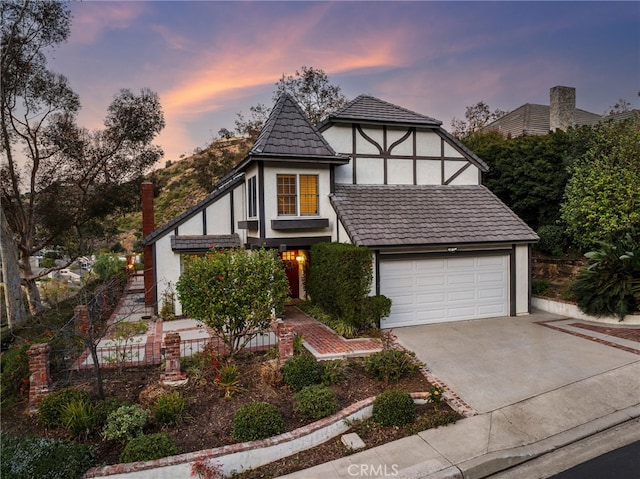 tudor home featuring a garage